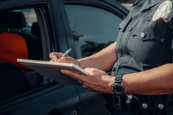 Police Officer Writing on a Notebook