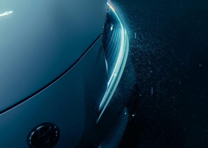 Sleek Car Headlight in Night Rainfall